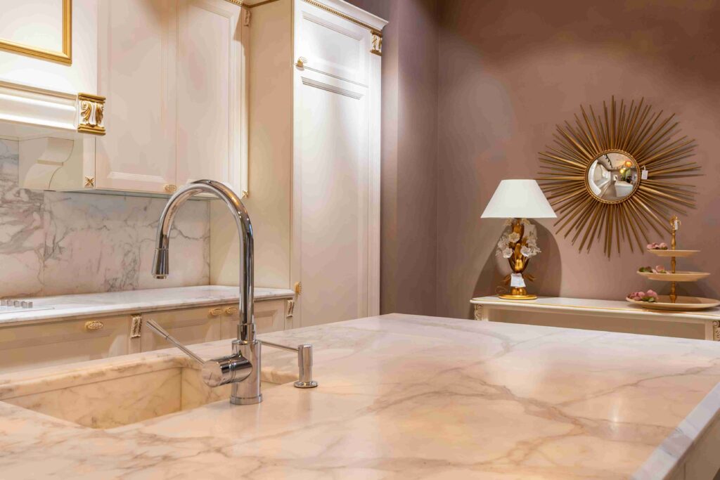 Calacatta quartz countertops with dramatic gray veining on a bright white background in a luxury modern kitchen