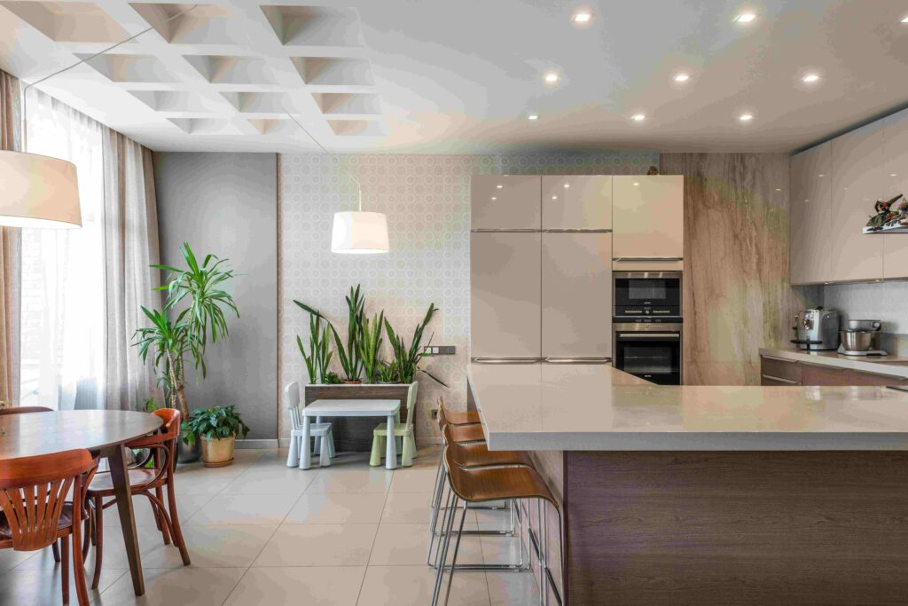 Green quartz countertops in a serene modern kitchen with white cabinets and wooden accents