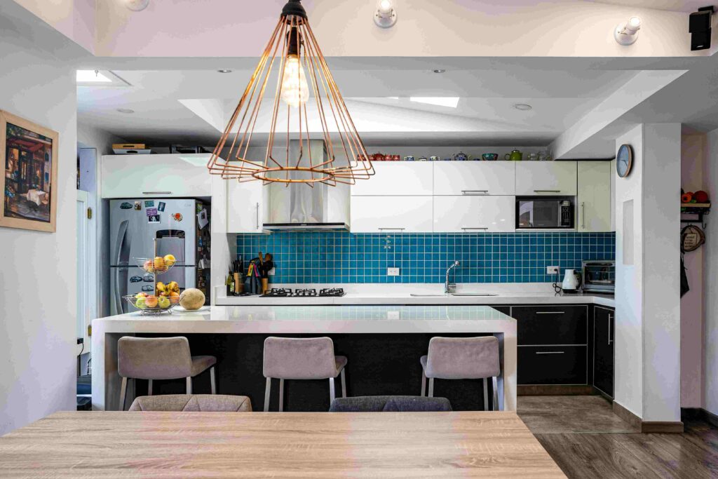 Blue quartz countertops in a coastal modern kitchen with white cabinets and brass accents